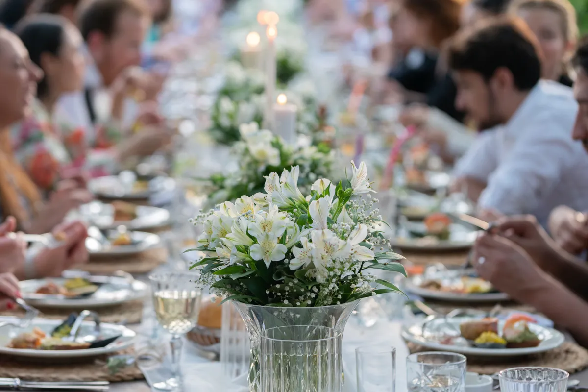 Wedding reception round table full of laughing guests in conversation